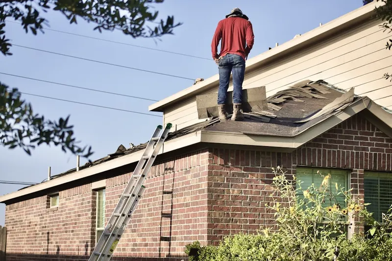 Professional roofer working on a residential roof in Waterfront